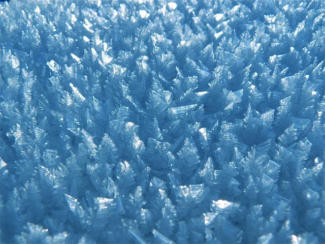 Lead acid battery maintenance: Close-up of ice crystals or frost, resembling sulfation buildup.