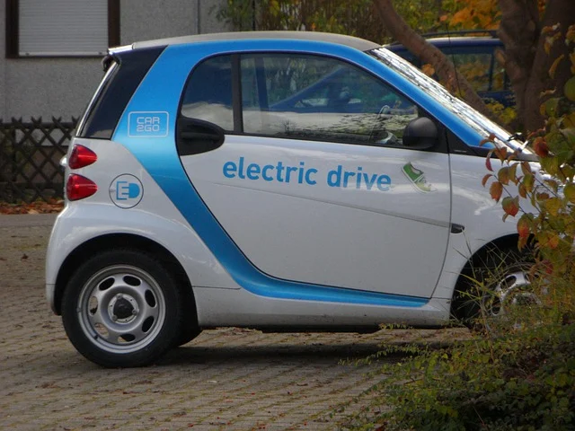 A white and blue electric car with 'electric drive' written on its side.