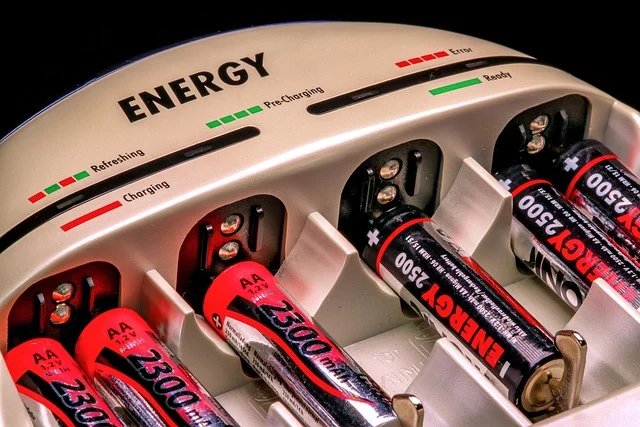 How long do solar batteries last: AA batteries charging in a battery charger with status indicators
