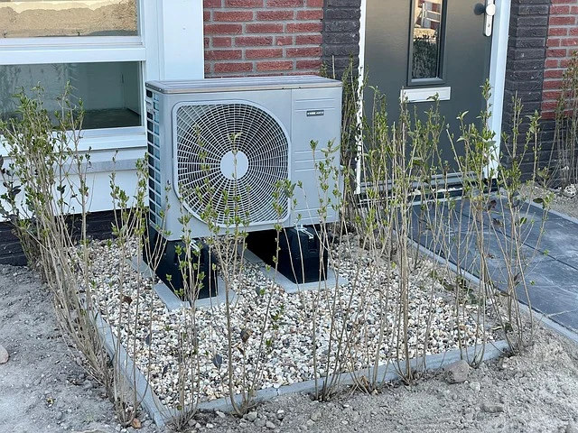 An outdoor heat pump unit next to a house