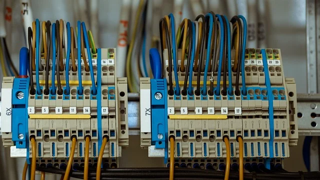 Close-up of electrical wiring, terminal blocks, and connections in a panel.