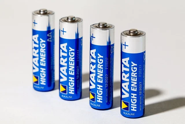 Four Varta AA alkaline batteries standing in a row.