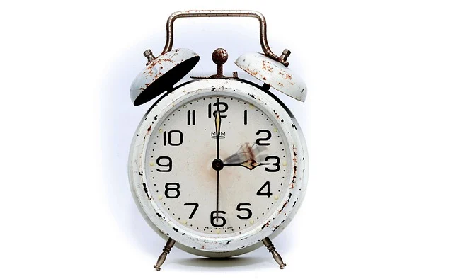 An old, rusty alarm clock with blurred hands, symbolizing time.