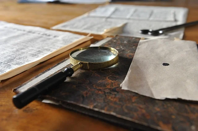 A magnifying glass on old documents, suggesting close examination of fine print.