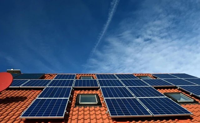 Solar panels installed on a tiled roof under a blue sky