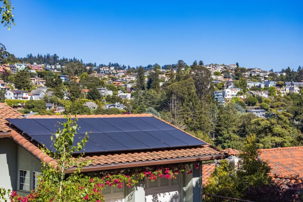 Solar panels on a house roof in a residential area.