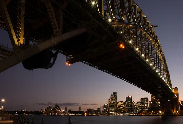 Sydney Harbour Bridge and city skyline at night, with Opera House visible