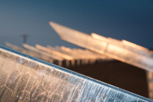 12v vs 24v vs 48v solar system: Abstract view of solar panels or a similar structure at sunset.