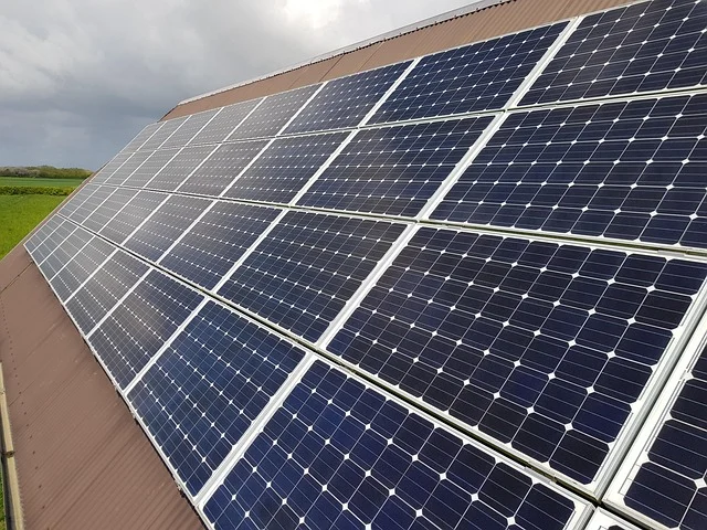 Solar panels on a roof, generating power for an off-grid home.