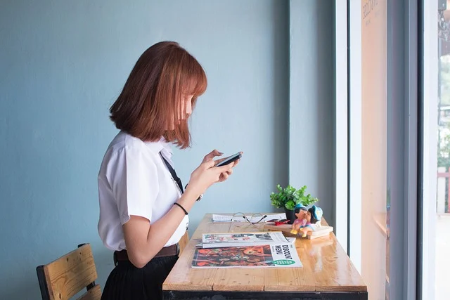 A person looking at their phone, possibly reading an app.