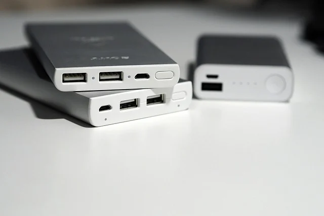 Mixing old and new batteries: Three power banks, two stacked, one in background.