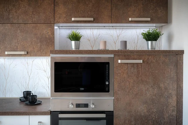 A modern kitchen with a built-in microwave and oven.